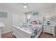 Charming bedroom with floral bedding, white furniture, and blue glass lamps on the nightstands at 1401 Wexford Way, Davenport, FL 33896