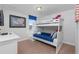 This bedroom has a white bunk bed and patriotic decor at 1401 Wexford Way, Davenport, FL 33896