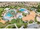 Expansive community pool area with lush landscaping, water features, lounge chairs, and nearby buildings at 1401 Wexford Way, Davenport, FL 33896