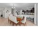 Open-concept dining room features seating for eight, neutral walls, and access to the kitchen and staircase at 1401 Wexford Way, Davenport, FL 33896