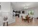 Bright dining room features seating for six, tile flooring, natural light and open access to kitchen and staircase at 1401 Wexford Way, Davenport, FL 33896