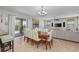 Open-concept dining area with seating for eight and a sliding glass door leading to a screened-in pool at 1401 Wexford Way, Davenport, FL 33896