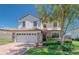 Inviting two-story home with stone accents, a two car garage, and a well-manicured front yard at 1401 Wexford Way, Davenport, FL 33896