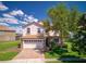 Beautiful two-story home boasts a tile roof, stone accents, a two-car garage, and a well-manicured front lawn at 1401 Wexford Way, Davenport, FL 33896