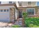 Charming home exterior with stone accents, well-manicured landscaping, and a welcoming entrance at 1401 Wexford Way, Davenport, FL 33896