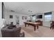 This game room has a pool table, a TV, and comfortable seating at 1401 Wexford Way, Davenport, FL 33896