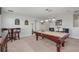 This game room has a pool table, seating and a table with bar stools at 1401 Wexford Way, Davenport, FL 33896