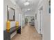 Bright hallway with neutral tones, tiled floors, and a glimpse of the living area, creating a welcoming atmosphere at 1401 Wexford Way, Davenport, FL 33896