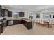 Spacious kitchen features dark wood cabinetry, granite counters, stainless steel appliances and a large island with seating at 1401 Wexford Way, Davenport, FL 33896