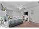 A comfortable main bedroom features a king bed, dresser, fan, and natural light at 1401 Wexford Way, Davenport, FL 33896