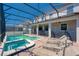 Sparkling pool and spa are enclosed in a screened patio with multiple chairs for lounging at 1401 Wexford Way, Davenport, FL 33896