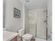 Bright bathroom with commode, vanity and glass enclosed shower at 1401 Wexford Way, Davenport, FL 33896