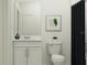 Clean bathroom with vanity, toilet, framed print and shower with dark curtain at 3454 Howell Dr, Lake Wales, FL 33859