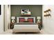Relaxing bedroom featuring a bed with decorative pillows, wood nightstands, and tasteful wall decor at 3454 Howell Dr, Lake Wales, FL 33859