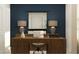 A cozy office design, featuring a wood desk with decorative lamps and a dark blue accent wall at 3454 Howell Dr, Lake Wales, FL 33859