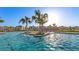 Community zero entry pool area with palms, landscaping and homes in the distance at 3454 Howell Dr, Lake Wales, FL 33859