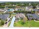 Aerial view of home showing long driveway, manicured lawn, landscaping, and surrounding neighborhood at 5446 Highlands Vista Cir, Lakeland, FL 33812