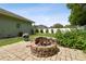 Backyard features a brick fire pit and manicured garden at 5446 Highlands Vista Cir, Lakeland, FL 33812