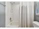 This bathroom includes a shower and tub combo with white tile at 5446 Highlands Vista Cir, Lakeland, FL 33812