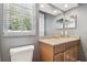 This bathroom includes a granite countertop, wood cabinets, and a window at 5446 Highlands Vista Cir, Lakeland, FL 33812