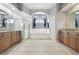 Spacious bathroom with dual vanities, walk-in shower, garden tub, and neutral tile flooring at 5446 Highlands Vista Cir, Lakeland, FL 33812