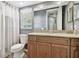 This bathroom includes a granite countertop, wood cabinets, and a large mirror at 5446 Highlands Vista Cir, Lakeland, FL 33812