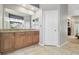 Bathroom with a double vanity featuring granite counters, tile flooring, and custom cabinets at 5446 Highlands Vista Cir, Lakeland, FL 33812
