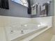 Close-up of the tub featuring tile backsplash and mounted hand towels at 5446 Highlands Vista Cir, Lakeland, FL 33812