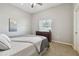This carpeted bedroom features a ceiling fan, neutral walls, and a window at 5446 Highlands Vista Cir, Lakeland, FL 33812
