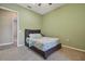 This cozy carpeted bedroom features a ceiling fan and soft green walls at 5446 Highlands Vista Cir, Lakeland, FL 33812