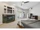 Spacious bedroom featuring a fireplace, neutral color palette, and direct access to the pool area at 5446 Highlands Vista Cir, Lakeland, FL 33812