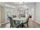 Dining room with seating for four featuring a mirrored wall and access to the patio and living spaces at 5446 Highlands Vista Cir, Lakeland, FL 33812