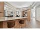 Open kitchen with wood cabinets, granite counters, stainless appliances and bar seating at 5446 Highlands Vista Cir, Lakeland, FL 33812