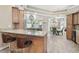 Open-concept kitchen with a breakfast bar featuring granite countertops and stylish seating adjacent to the dining area at 5446 Highlands Vista Cir, Lakeland, FL 33812