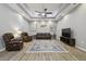 Spacious living room featuring neutral walls, a coffered ceiling, tile floors and comfortable furnishings at 5446 Highlands Vista Cir, Lakeland, FL 33812