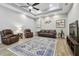 Bright and open living room with neutral walls, a coffered ceiling, tile floors and comfortable furnishings at 5446 Highlands Vista Cir, Lakeland, FL 33812