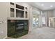 Cozy living room featuring a fireplace with custom shelving and sliding glass doors to the pool at 5446 Highlands Vista Cir, Lakeland, FL 33812
