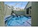 Relaxing in-ground pool surrounded by a screened enclosure and manicured landscaping at 5446 Highlands Vista Cir, Lakeland, FL 33812