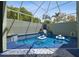 A private enclosed pool area with a waterfall feature and mature landscaping at 5446 Highlands Vista Cir, Lakeland, FL 33812