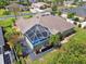 Aerial view of the screened-in pool and patio area, surrounded by lush greenery and landscaping at 5446 Highlands Vista Cir, Lakeland, FL 33812