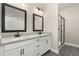 Well-lit bathroom with double vanity, granite countertops, modern fixtures, and a glass-enclosed shower at 7704 Somersworth Dr, Kissimmee, FL 34747