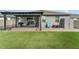 A backyard with lush artificial turf, a brick-paver patio, a shed, and a pergola at 140 Trinity Ridge Cir, Davenport, FL 33897