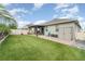 A backyard with lush artificial turf, a brick-paver patio, a shed, a slide, and a pergola at 140 Trinity Ridge Cir, Davenport, FL 33897