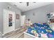 Bedroom features wood-look floors, a ceiling fan, -friendly decor, and a full-length mirrored door at 140 Trinity Ridge Cir, Davenport, FL 33897