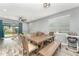 Open concept dining area with a large wood table, and a sliding glass door that leads to the backyard at 140 Trinity Ridge Cir, Davenport, FL 33897