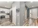 Hallway leading to the modern kitchen features wood flooring and an entryway at 140 Trinity Ridge Cir, Davenport, FL 33897