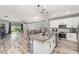 Open-concept kitchen flowing into the living area and backyard, with wood floors and stainless appliances at 140 Trinity Ridge Cir, Davenport, FL 33897