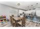 Bright kitchen with wood floors, an island with bar seating and stainless steel appliances at 140 Trinity Ridge Cir, Davenport, FL 33897
