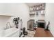 Laundry room with washer, dryer, sink, and storage shelves at 140 Trinity Ridge Cir, Davenport, FL 33897