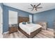 Bedroom with blue walls, ceiling fan, wood floors and a full size bed at 140 Trinity Ridge Cir, Davenport, FL 33897